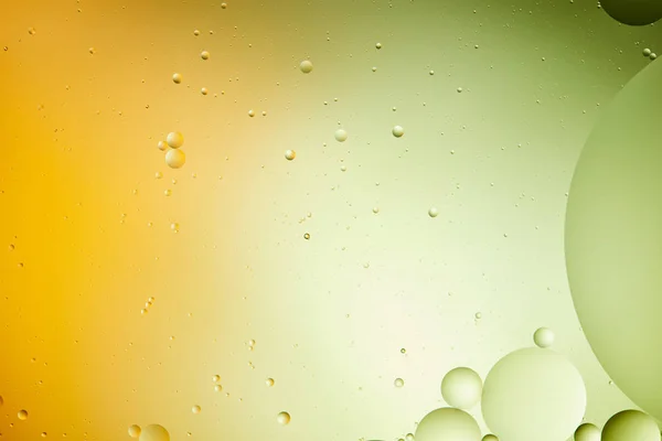 Creative abstract background from mixed water and oil in green and orange color — Stock Photo