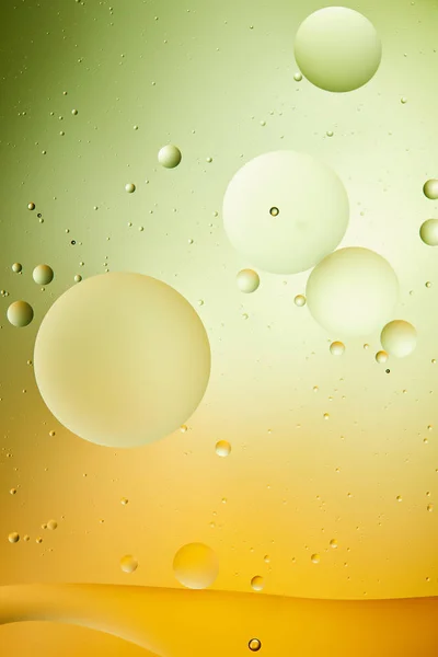 Creative background from mixed water and oil in green and orange color — Stock Photo