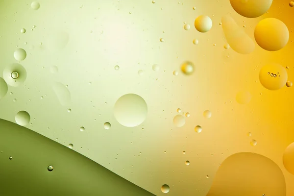 Fond créatif abstrait de l'eau et de l'huile mélangées en couleur verte et orange — Photo de stock