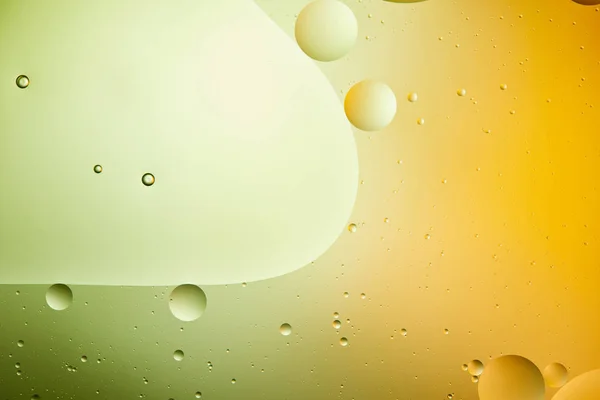 Beautiful abstract background from mixed water and oil in green and orange color — Stock Photo