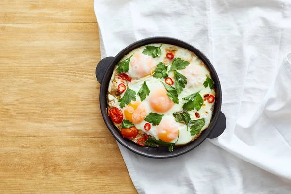 Top view of fried eggs on napkin on wooden table — Stock Photo