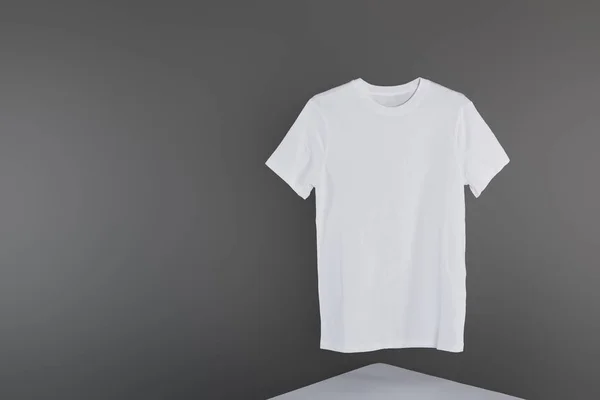Blank basic white t-shirt on grey background — Stock Photo