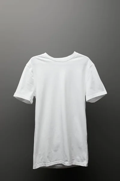 Blank basic white t-shirt on grey background — Stock Photo