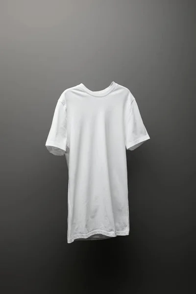 Blank basic white t-shirt on grey background — Stock Photo