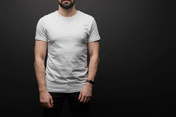 Cropped view of bearded man in blank basic grey t-shirt isolated on black — Stock Photo