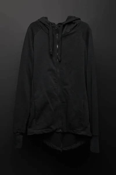 Blank basic black hoodie on black background — Stock Photo