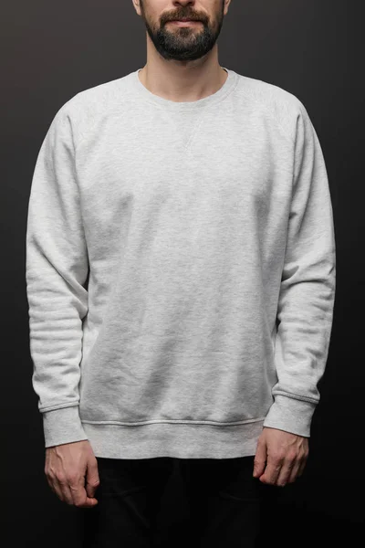 Cropped view of bearded man in blank basic grey sweatshirt isolated on black — Stock Photo