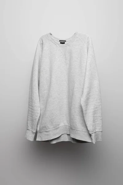 Blank basic grey sweatshirt on grey background — Stock Photo