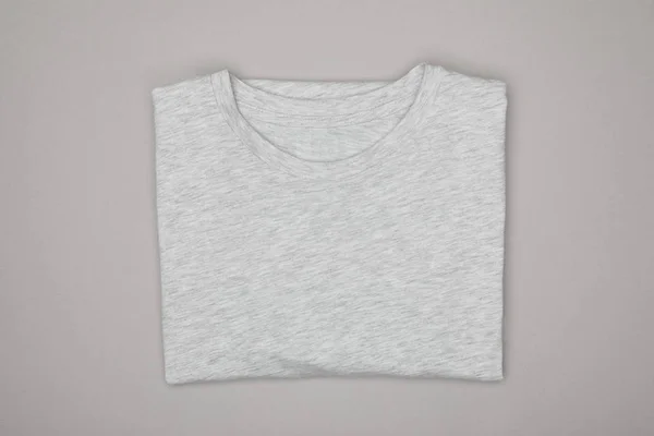 Top view of blank basic grey t-shirt isolated on grey — Stock Photo