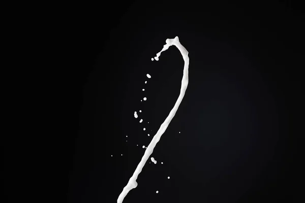 Fresh white milk splash with drops isolated on black — Stock Photo