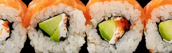 Close up view of fresh delicious Philadelphia sushi with avocado, creamy cheese, salmon and masago caviar, panoramic shot — Stock Photo