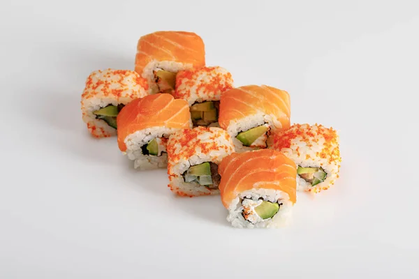 Delicious Philadelphia and California sushi with salmon and masago caviar on white background — Stock Photo