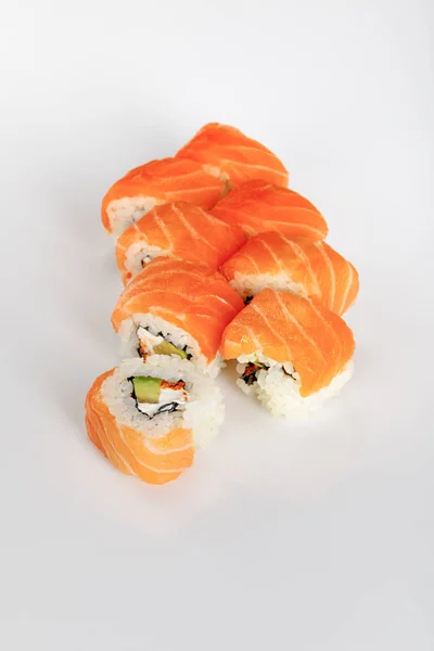 Delicious Philadelphia sushi with avocado, creamy cheese, salmon and masago caviar on white background — Stock Photo