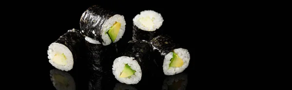 Delicious sushi maki with avocado isolated on black, panoramic shot — Stock Photo