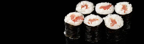 Delicious sushi maki with tuna isolated on black, panoramic shot — Stock Photo