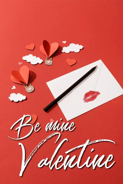 Paper clouds and heart shaped air balloons and envelope near be mine valentine lettering on red background — Stock Photo