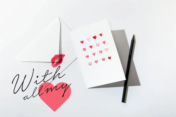 Top view of greeting card with hearts near envelope with lip print near with all my lettering on white background — Stock Photo