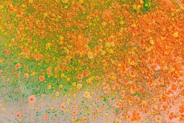 Orange, yellow and green colorful holi paint explosion — Stock Photo