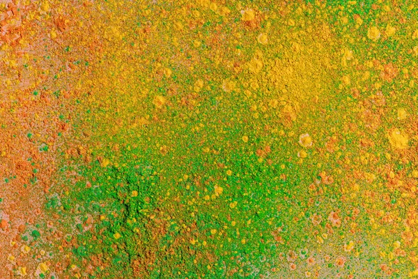 Orange, yellow and green colorful holi paint explosion — Stock Photo