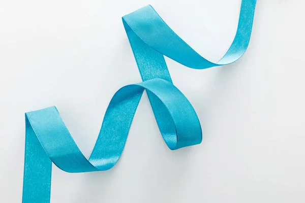 Top view of blue decorative curved ribbon on white — Stock Photo