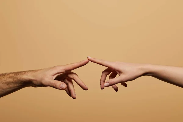 Cropped view of man and woman touching with fingers isolated on beige — Stock Photo