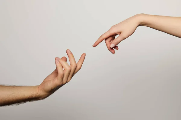 Cropped view of man and woman reaching for each other isolated on white — Stock Photo