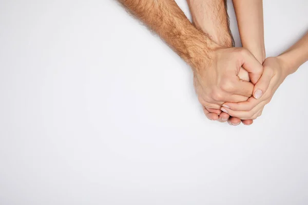Vista superior do casal de mãos dadas isoladas no branco — Fotografia de Stock