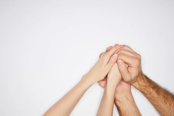 Vista superior de pareja cogida de la mano aislada en blanco - foto de stock