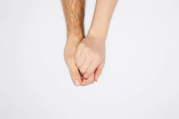 Vue de dessus du couple tenant les mains isolées sur blanc — Photo de stock
