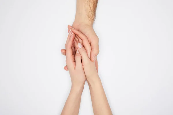 Vista superior de pareja cogida de la mano aislada en blanco - foto de stock