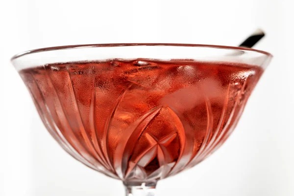 Close up of red cocktail with frozen ice cubes isolated on white — Stock Photo