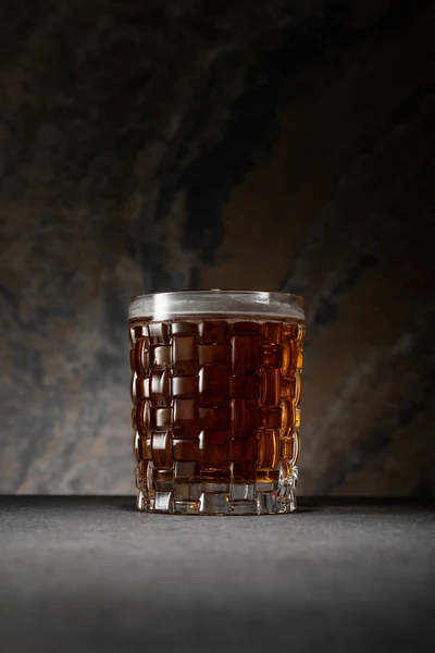 Glass of alcohol beer on textured granite background — Stock Photo