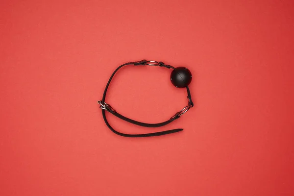 Top view of black gag isolated on red — Stock Photo