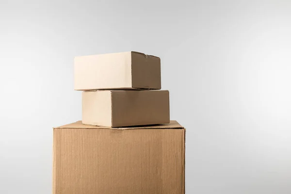 Boîtes en carton empilées isolées sur gris — Photo de stock