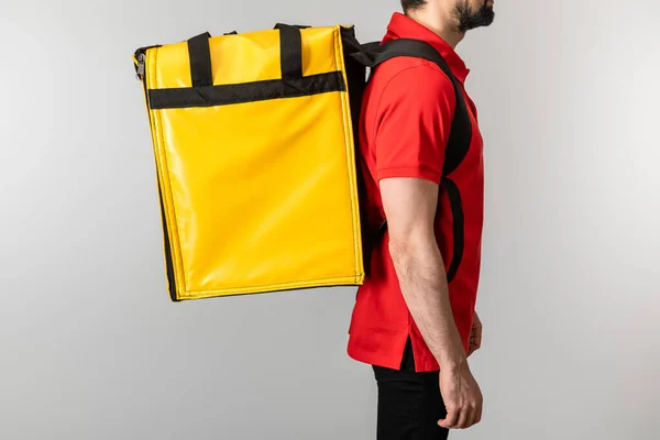 Cropped view of delivery man in uniform with thermo bag isolated on grey — Stock Photo