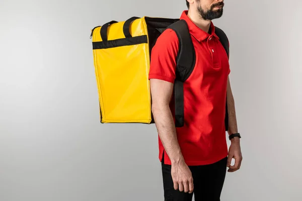 Cropped view of bearded courier with thermo backpack isolated on grey — Stock Photo