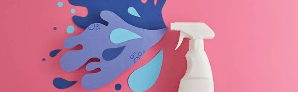 Panoramic shot of composition with detergent bottle and blue water splash made of paper, on pink — Stock Photo