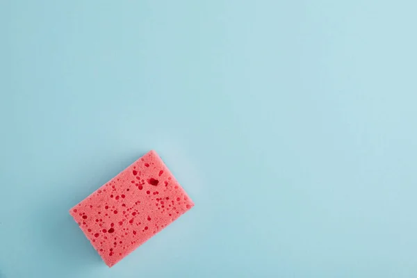 Top view of pink sponge for house cleaning on blue with copy space — Stock Photo