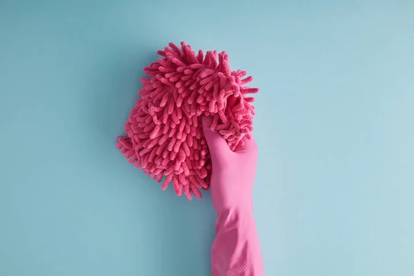 Top view of housekeeper in rubber glove holding pink rag on blue — Stock Photo