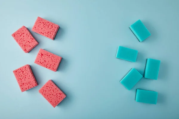 Top view of blue and pink sponges for house cleaning on blue — Stock Photo
