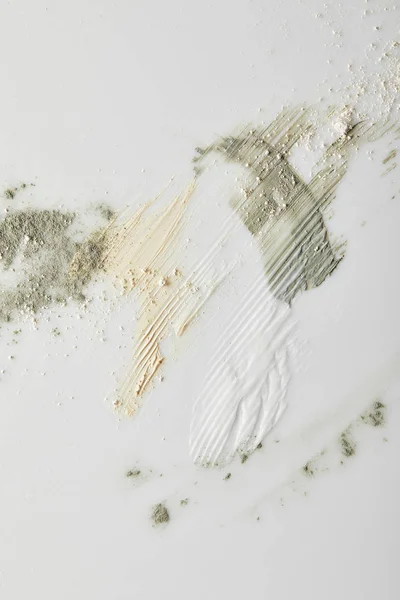 Top view of clay powder, cosmetic and tone cream brushstrokes on grey background — Stock Photo