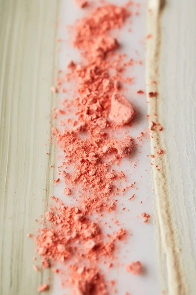 Selective focus of cosmetic and tone cream, clay brushstrokes with pink blusher — Stock Photo