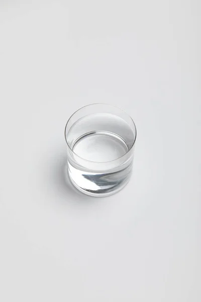 Transparent glass of fresh water on white surface — Stock Photo