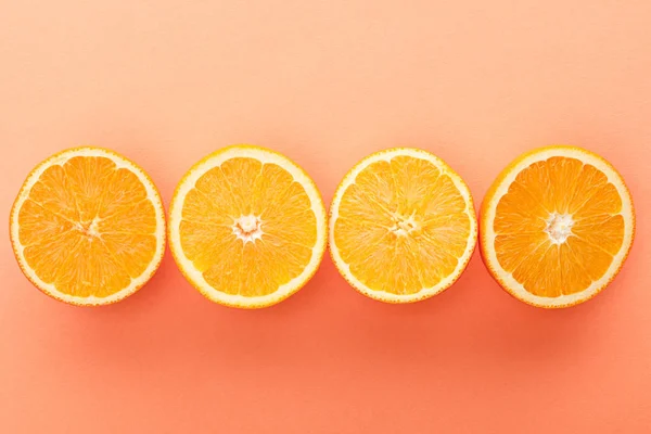 Draufsicht auf geschnittene Zitrusfrüchte auf orangefarbenem Hintergrund — Stockfoto