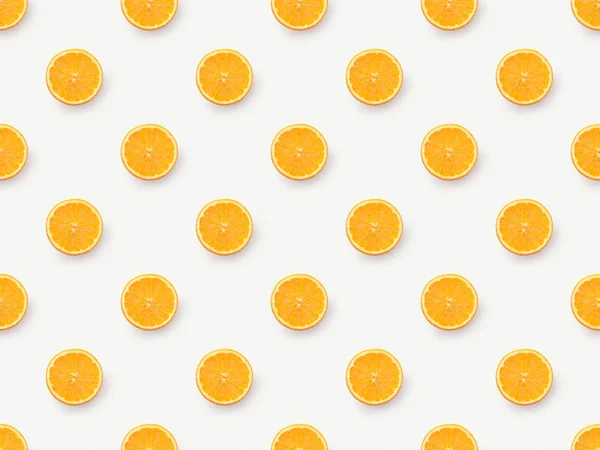 Вид зверху на помаранчеві скибочки на білому тлі — стокове фото