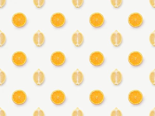 Top view of orange slices and lemons halves on white background — Stock Photo