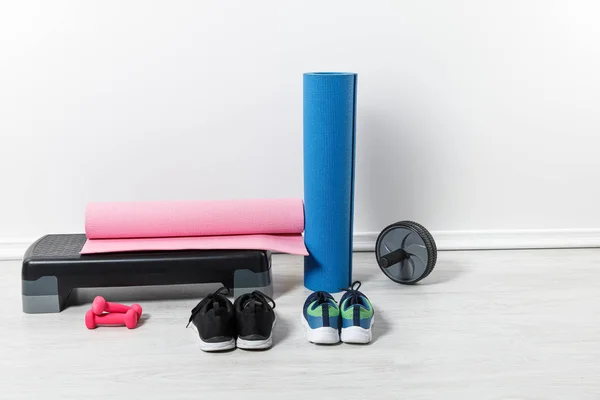 Fitness mats and sports stuff on floor at home — Stock Photo