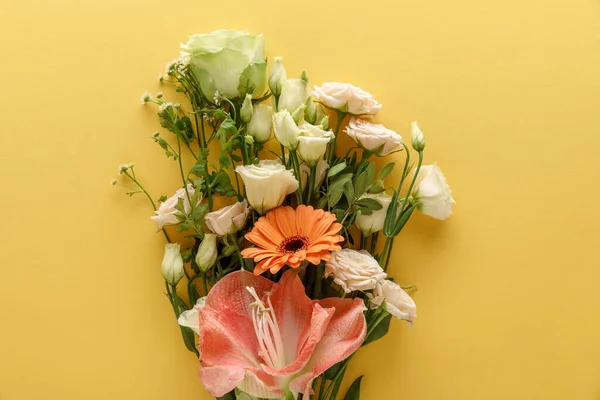 Top view of spring floral bouquet on yellow background — Stock Photo