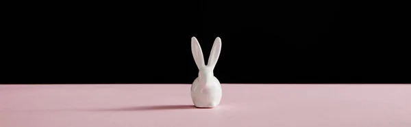 Decorative white bunny isolated on black background, panoramic shot — Stockfoto