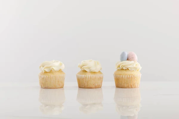 Delicious cupcakes isolated on grey — Stock Photo